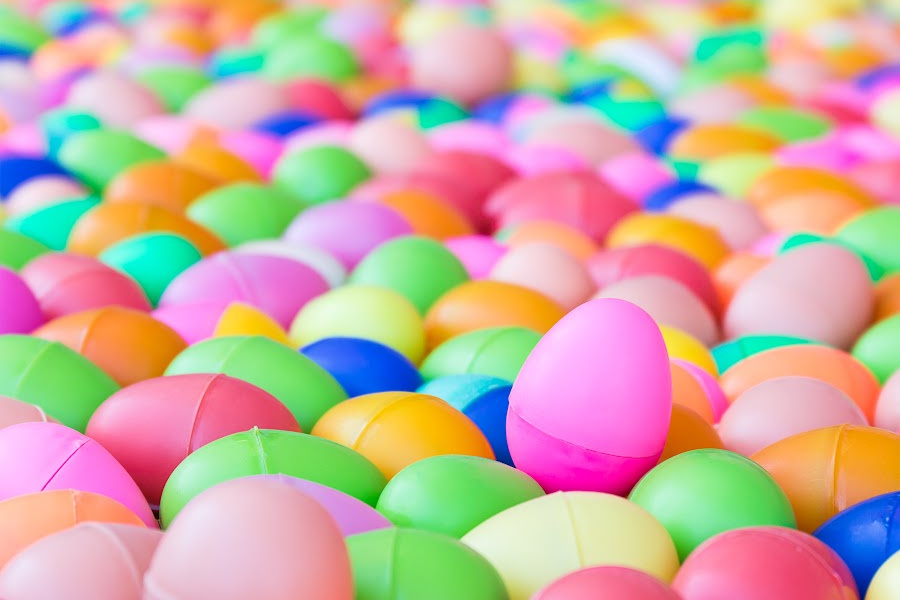many colorful plastic Easter eggs fill the pic.